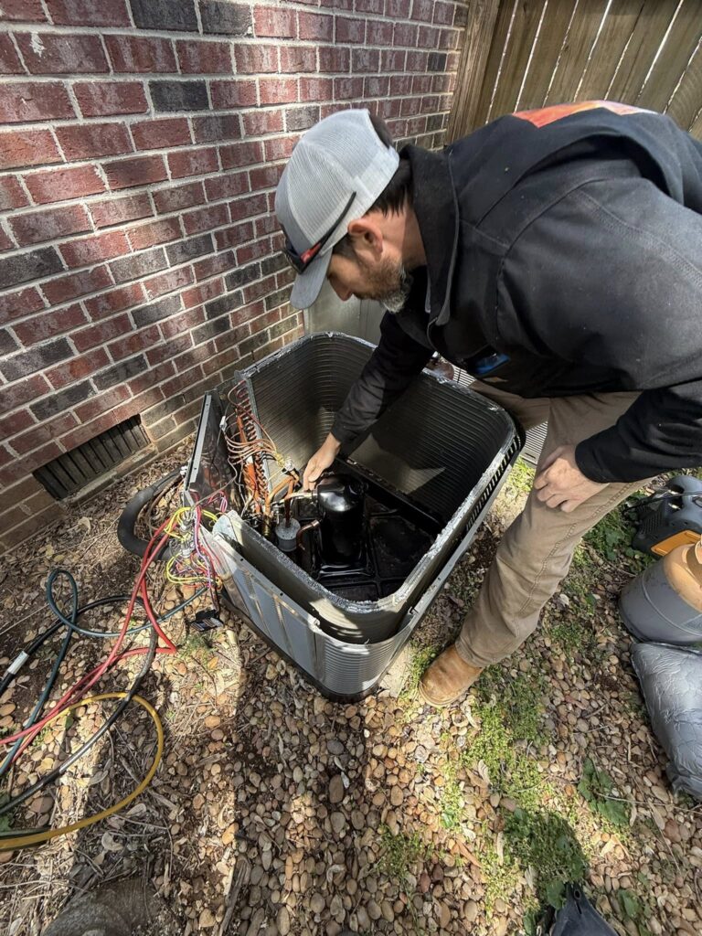 HVAC technician repairing outdoor unit in Murfreesboro TN